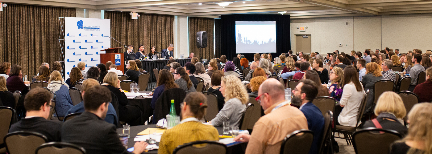 Attendees at a meeting inside a conference room