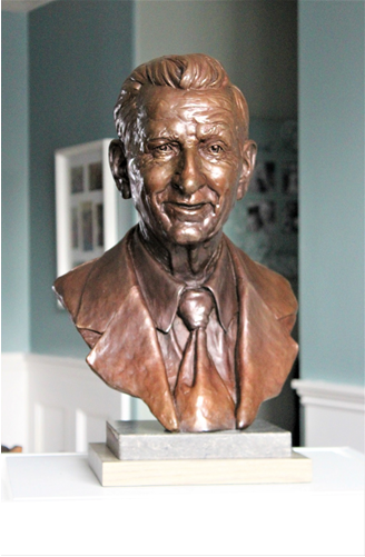 bronze bust of a smiling man