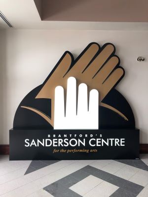 Art sculpture of two hands clapping, with the words "Brantford's Sanderson Centre for the performing arts" on the piece.