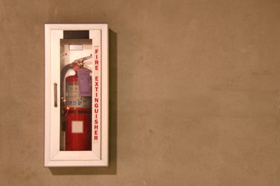 Portable Fire Extinguisher A fire extinguisher in a glass case on a wall
