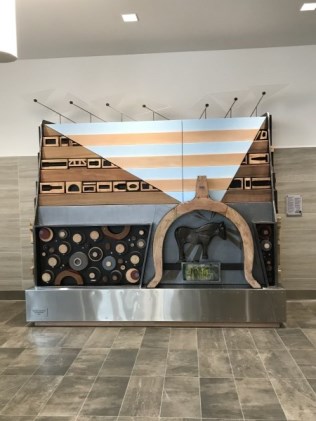large square sculpture made of various materials