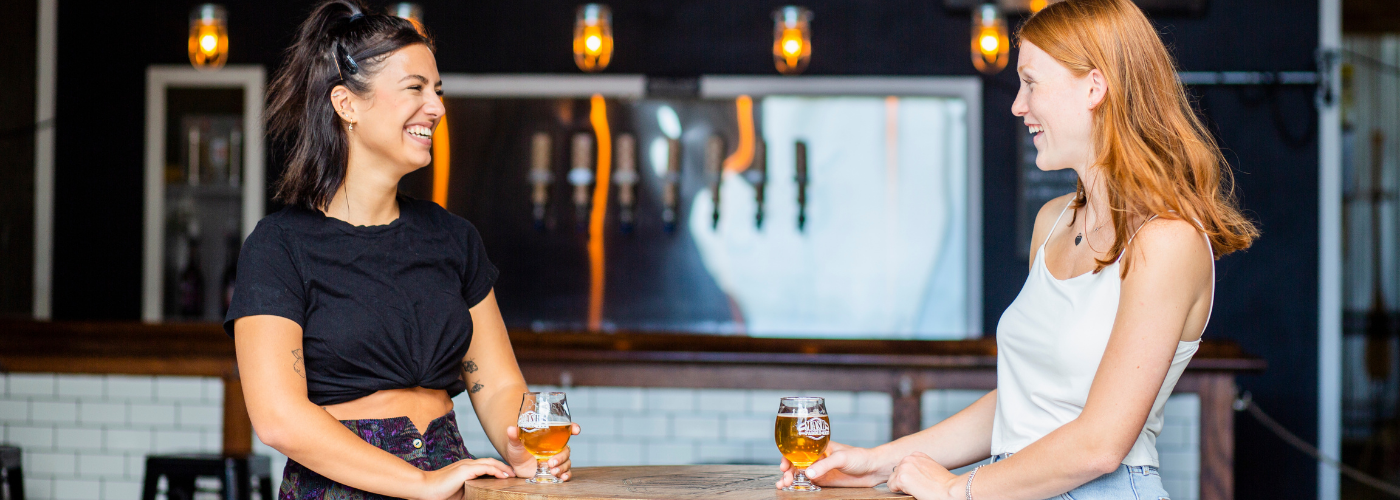Two women sampling craft beer at brewery